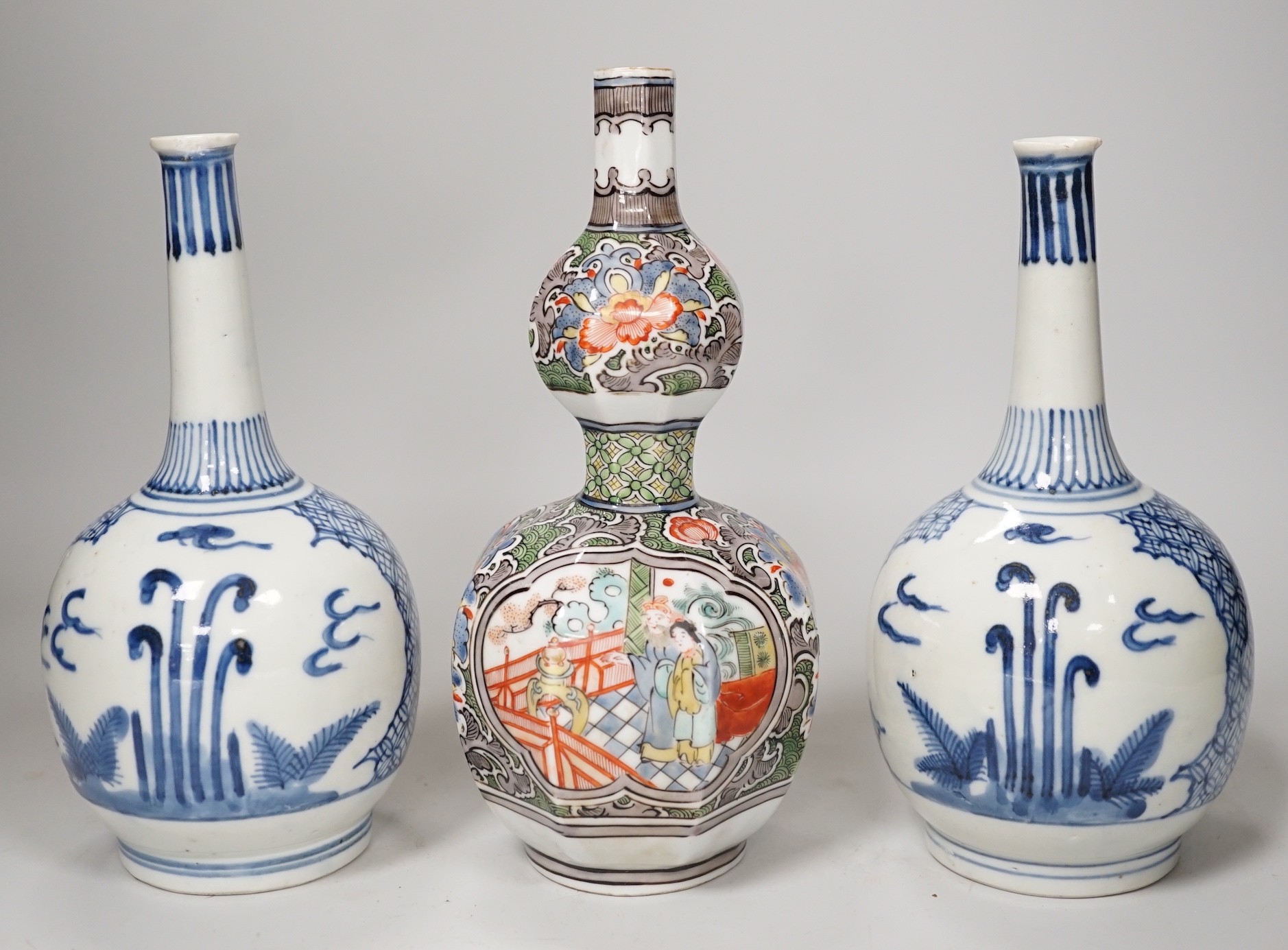 A Chinese famille verte octagonal double gourd vase, together with a pair of Chinese blue and white bottle vases, tallest 20cm